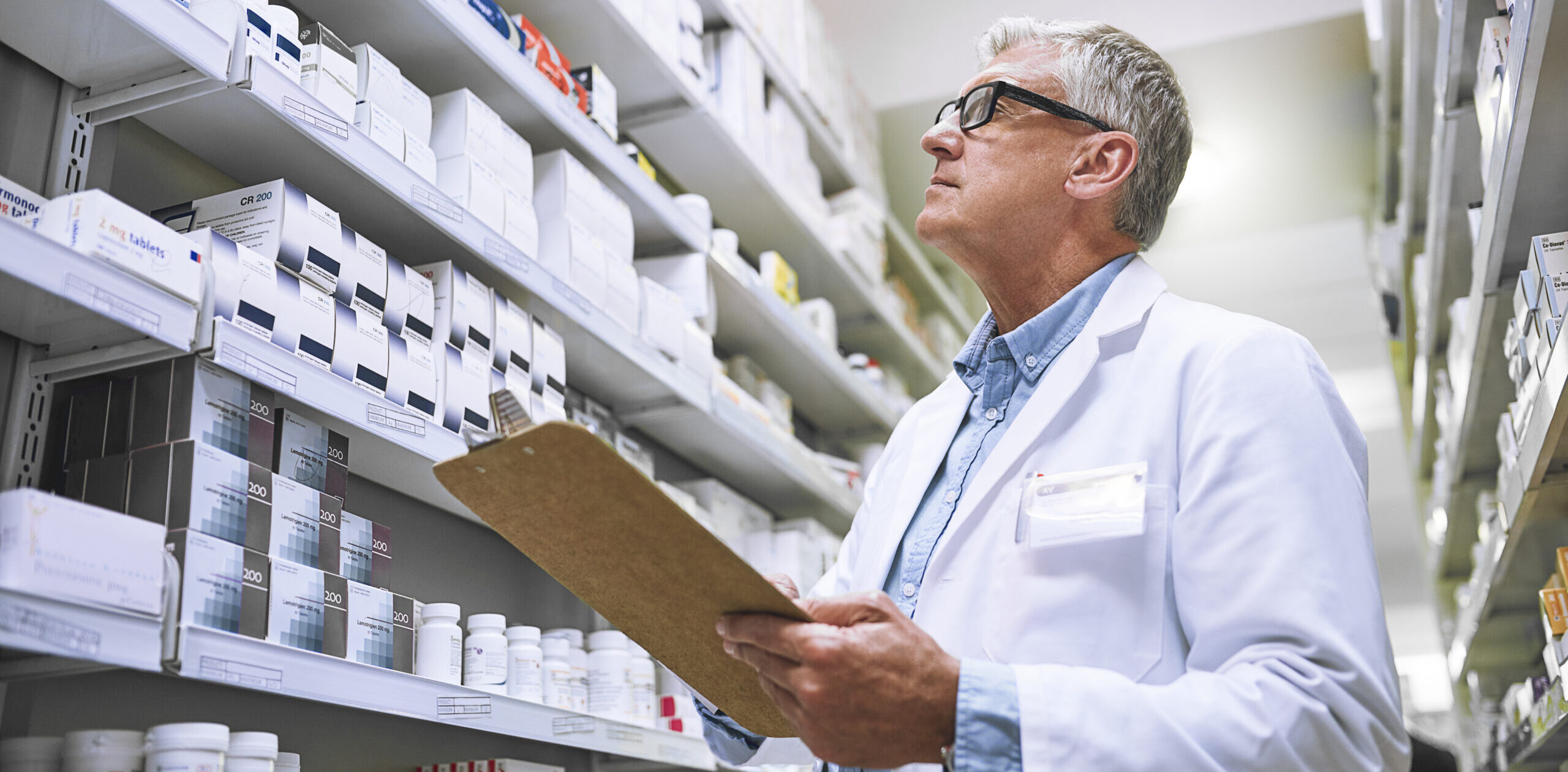 Pharmacist searching for a prescription for an urgently needed medicine